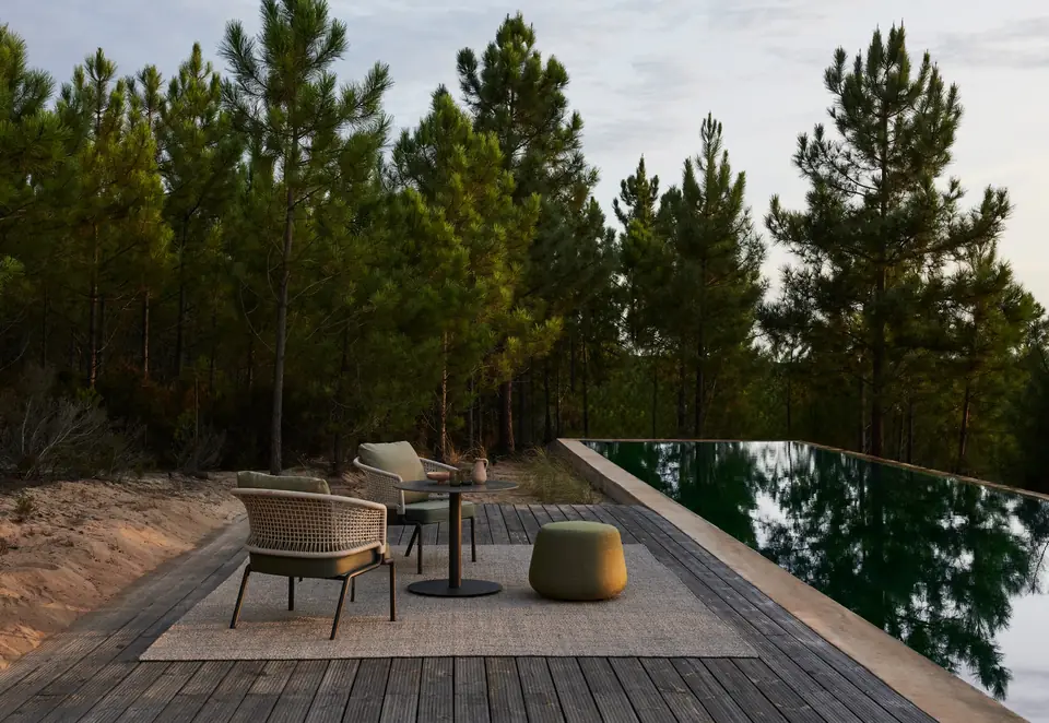 Tribù CTR armchairs with open rope-woven backs around an outdoor dining table