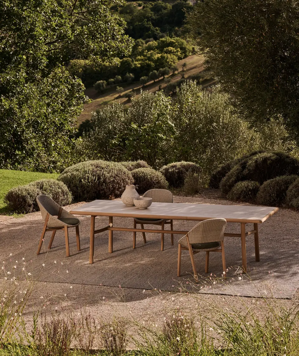 Tribù Elio sofas and lounge chairs with woven shells and deep cushions on an open terrace