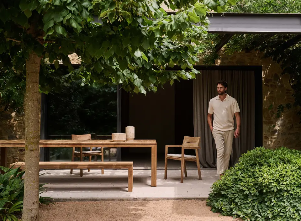 Tribù Kos solid teak armchairs and dining table on a sunlit terrace