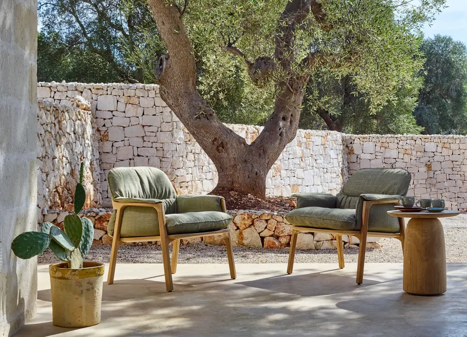 Tribù Nomad lounge chair and pouf from the Nomad collection on a shaded outdoor terrace