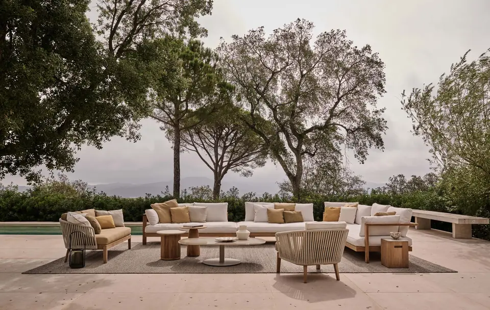 Tribù Pure 2-seat sofa and Pure armchair with a lounger beside a pool